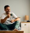 smiling-man-enjoys-coffee-in-his-bedroom-2026-03-16-03-31-15-utc