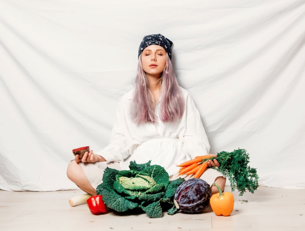 young-woman-meditating-with-vegetables-in-studio-2026-03-09-07-15-51-utc